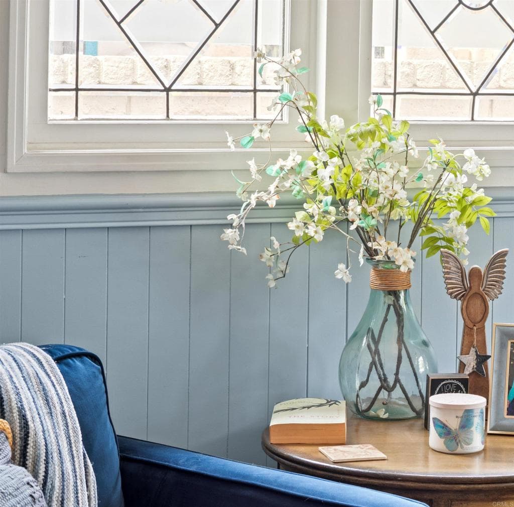 A reading nook with navy wainscoting and leaded glass (as-is)
